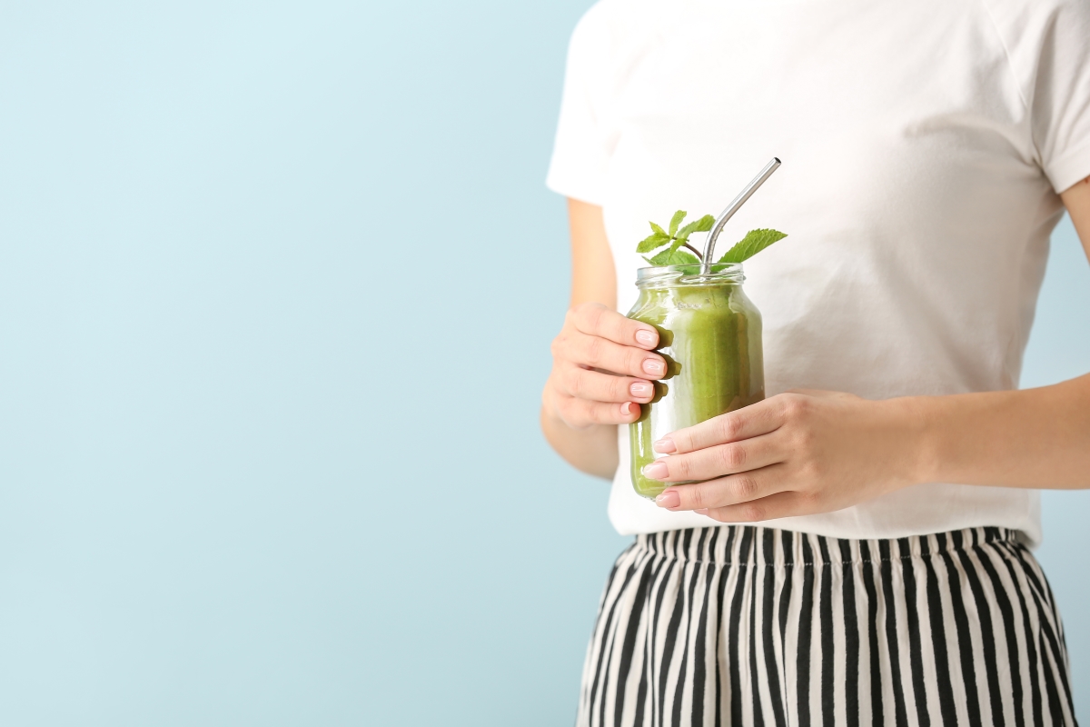 Lady holding green smoothie