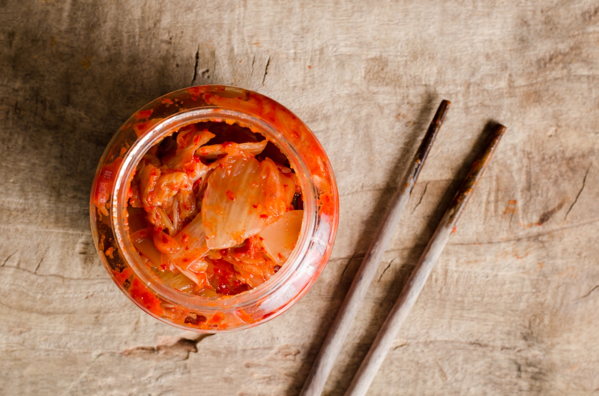 jar of homemade kimchi and chopsticks